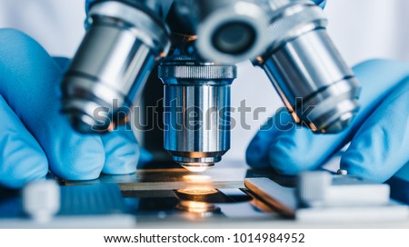 Close-up shot of microscope with metal lens at laboratory. Royalty-Free Stock Photo #1014984952