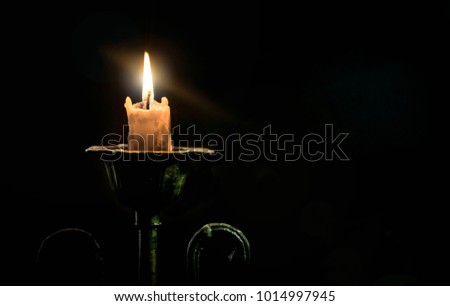 The candle in the bronze candlestick