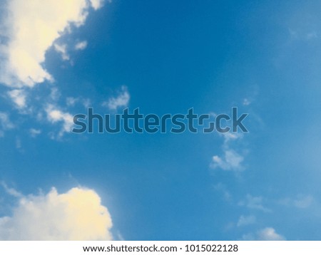 Blue sky and white clouds with space for your text and design.Concept be used for freedom of think and life,background,desktop,banner,book,card, relax time on summer and refresh your body.Blur picture