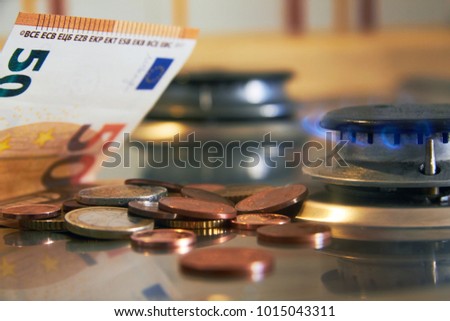 increase in gas prices in Europe for the population. crisis in Europe. high prices for utilities. combustion of money. 50 euro banknote and euro cents on a gas stove next to a lighted hob Royalty-Free Stock Photo #1015043311