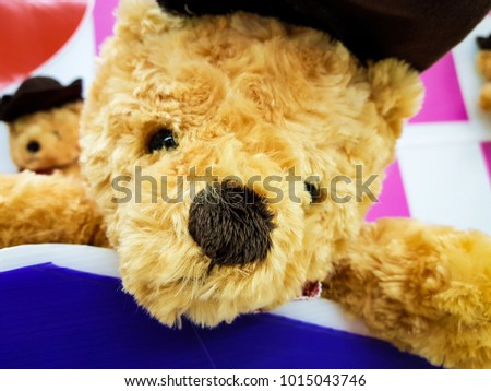 Cute teddy bear with heart on pink and white background, Sign of love