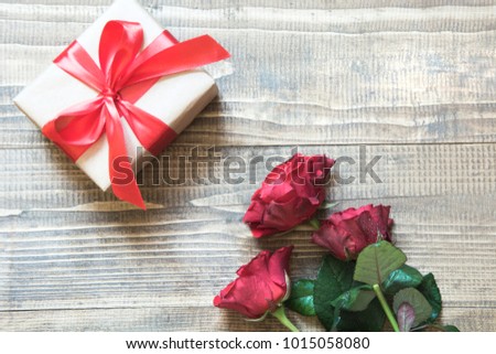 Valentine's day card with love gift and red roses. View from above. Copy space. Flat lay. Mother day.