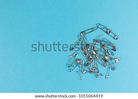 safety pins with blue background