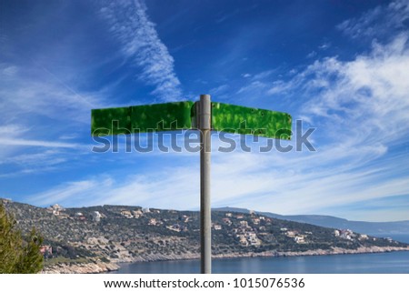 road sign near the sea overlooking the sky and hill, Greece