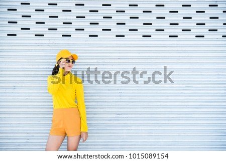 Portrait of beautiful asian woman in yellow cloths,Hipsters girl wear yellow hat  take a picture,Thailand people