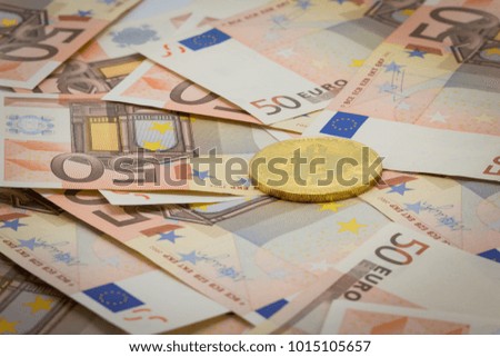 Golden bitcoin on 50 Euro Banknotes. Mining Concept, Electronic money exchange concept, conceptual image of bitcoin mining and trading, Accepting bitcoin for payment, Finance, Digital money