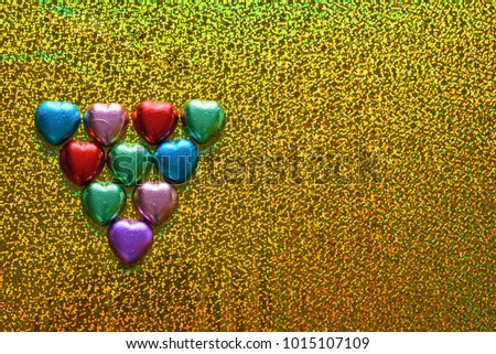 Chocolate heart candy on holographic trendy background.Valentines day, International woman's day, party invitation background.Copy space for text.