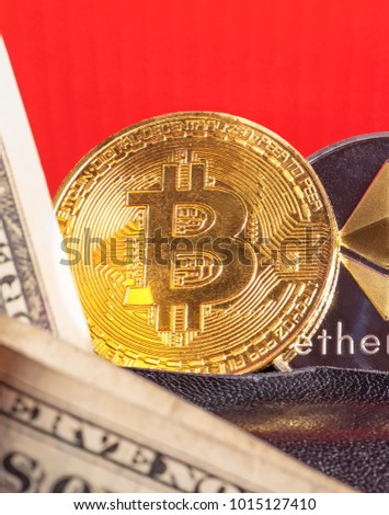  Bitcoin with dollars in a black purse. Golden bitkoyny (digital virtual money).