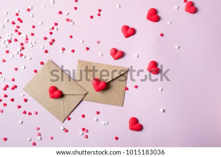 Two craft paper postal envelope with multicolor sweet sugar candy hearts. Love message or gift concept.