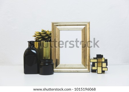Gold picture frame with decorations. Mock up for your photo or text Place your work, print art, shabby style, white background, black and gold accessories 