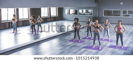 Attractive young sport girls are doing yoga together. Group training. Healthy lifestyle concept.