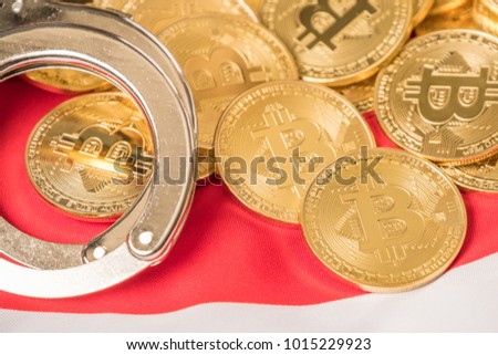 Conceptual image of golden bitcoin replica with handcuffs over Japan flag