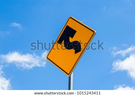 Road sign on a yellow background. Road sign warning of dangerous left curve.