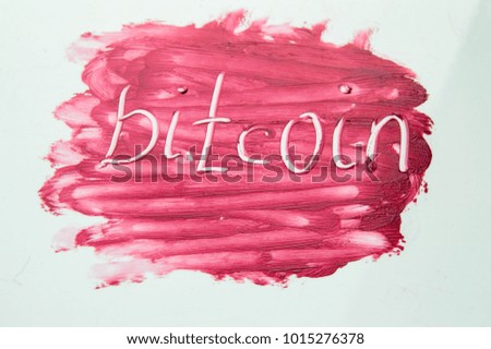 Cryptocurrency Bitcoin symbol on textured background red lipstick.