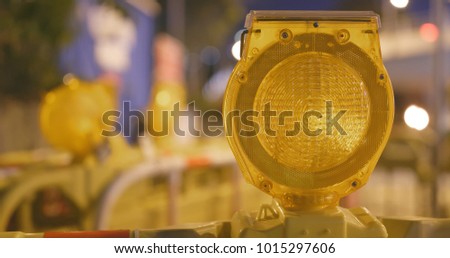 Warning light in yellow in construction site at night 