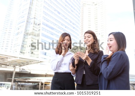 Young asian business woman excited that getting higher pay rate more than colleagues, business woman encourages with colleagues, business people success in job, business co-working teamwork concept