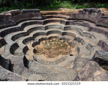 Lotus Pond or Nelum Pokuna in the ancient city Polonnaruwa, Sri Lanka, in a design of 8 petaled lotus flowers is believed to be used for ritual baths for the pilgrims.
