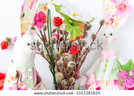 rabbits tilde and a bouquet of pussy willow on palm Sunday and Easter