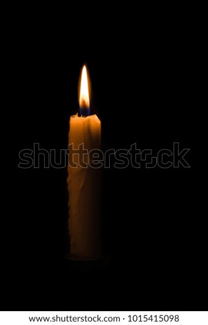 portrait of One light candle burning brightly in the black background