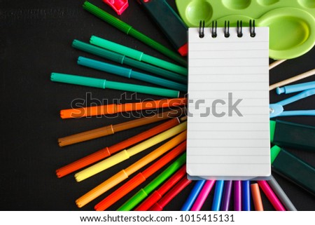close up portrait of artist supplies for painting on black wooden background