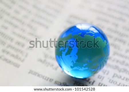 blue earth( Marble) on the  newspaper