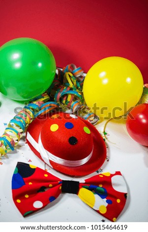 Party hat with bow, balloons and streamers, oblique photo