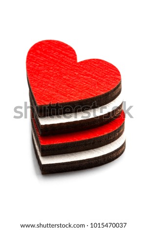 Stack of hearts with key on white background.