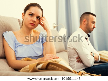 Sad female is depressing and husband is supporting her at home.