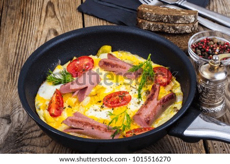 Breakfast for the family. Omelette with sausages. Studio Photo