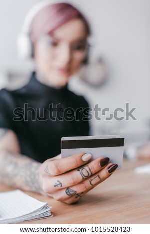 close-up view of young woman holding credit card