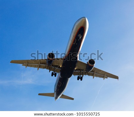 New passenger plane departing from runway in airport in afternoon Royalty-Free Stock Photo #1015550725