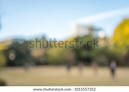 Abstract blur people in city park autumn season bokeh background