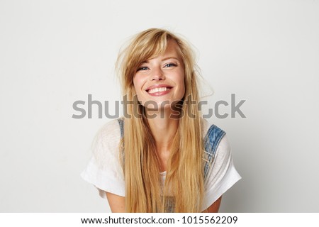 beautiful young woman smiling to camera in white studio Royalty-Free Stock Photo #1015562209