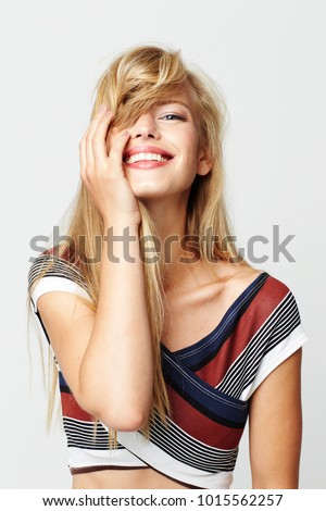 Gorgeous blond girl in striped fashion, portrait Royalty-Free Stock Photo #1015562257