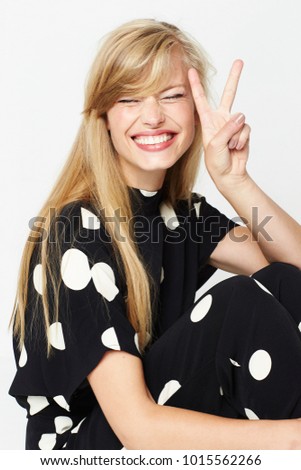 Polka dot babe with peace sign and eyes closed