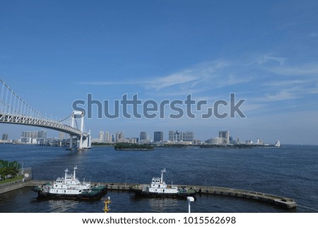 Seaview at a port near a bridge with a blue sky