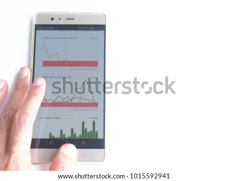 Businessman Analyzing Graph On Cell Phone In Office, Education, statistics, people and technology concept - close up of male hands pointing finger to graph.