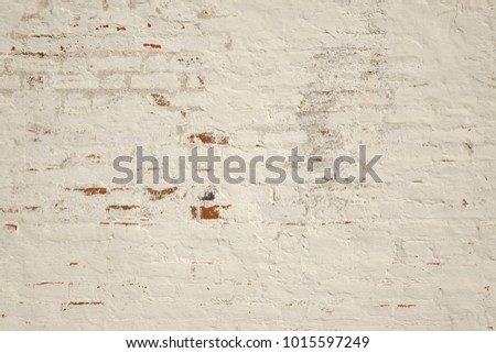 Biege and Gray Dirty Plaster Wall, With Falling Off Flakes Of Paint. Rough Surface. Old Weathered Painted Background Texture. Vintage Timber Background. Peeled Plaster Brickwall