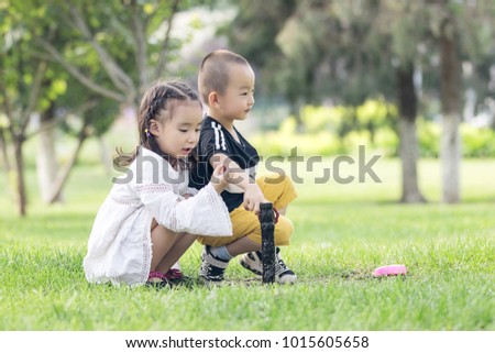 Lovely little Asian Boys and beautiful girls playing on the park's meadows