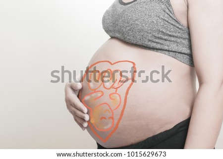 Pregnant woman with painted Cartoon embryonic unborn child on her stomach,Use computer graphics techniques, like coloring posters.
Concept of Health Care During Pregnancy.