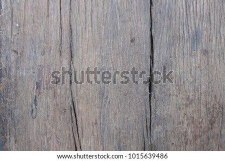 Wooden boards with vertical stripes and cracks.