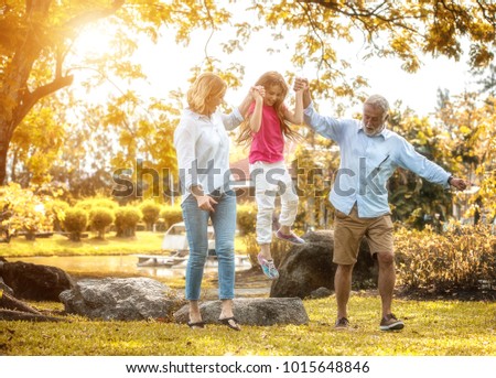 Happy family and daughter playing together in the garden. Soft focus concept.