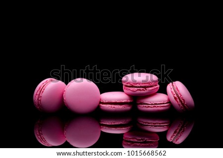 macaroons on black background isolated.top view.pink.best