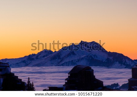 Surrealistic space landscape with mountains blending into the sea of clouds on sunset in the French Alps, Avoriaz