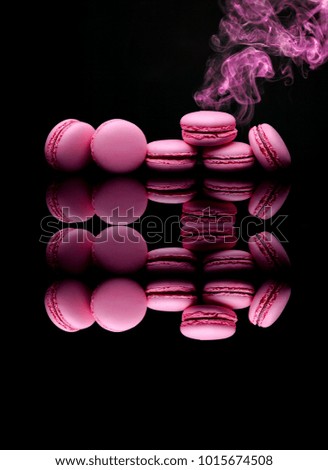 Collage with pink sweets, macarons . flames pink .two images in one. on black 