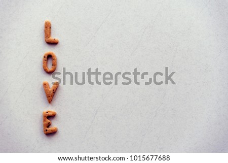 The word "LOVE" made from cracker on white background