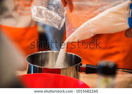 Adding sugar in saucpan close