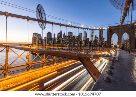 Crossing over the Brooklyn Bridge during sunset in New York City