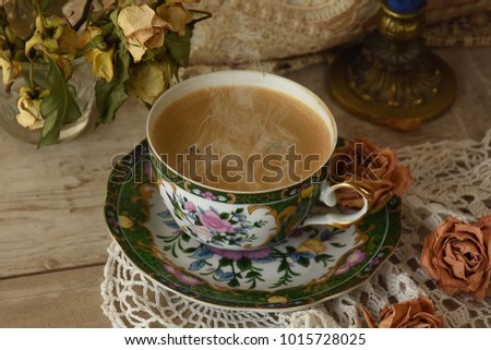 Hot aromatic coffee, in a beautiful porcelain cup, decorated with a spring motif.