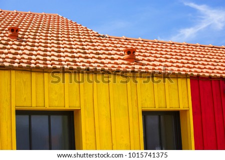 Close-up of colorful fishing huts in red and yellow
